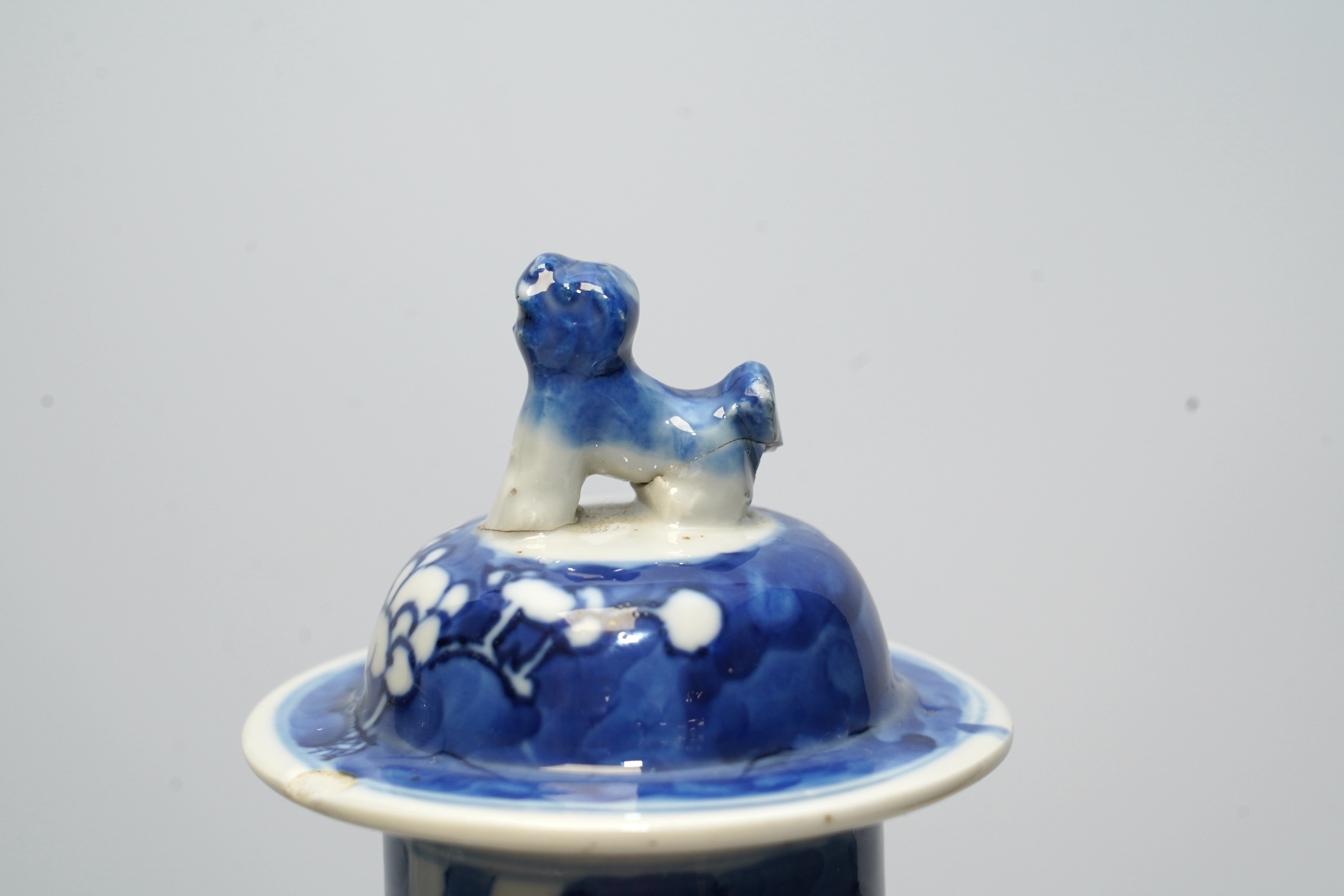 A pair of Chinese blue and white prunus baluster vases and covers, 31cm high. Condition - one vase good, the other pieces poor